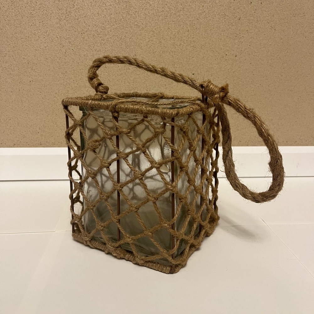Weaved rope basket around a glass vase